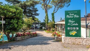 Señal de recepción del Hotel Marco Polo y Parco del Garda, que indica servicios como estacionamiento y piscina.