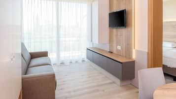 Deluxe Apartment, 1 Bedroom | Living area | 20-inch TV with satellite channels