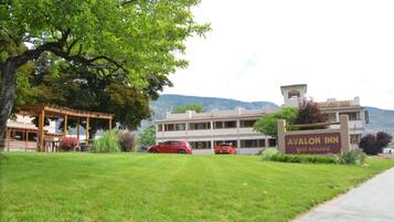 A hotel with a sign reading "Avalon Inn Rest Assured."