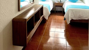 A room with two beds, a wooden bench, a mirror, and a window with curtains. - Hotel Concorde (Punta del Este)
