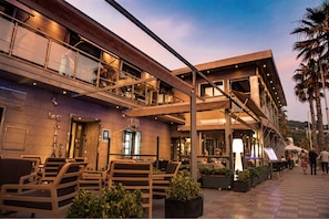 A modern building with outdoor seating, a visible entrance, and a sign reading "Lac Aletay". - H.Boutique la Caleta bay (Almunecar)