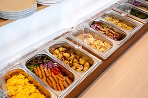 A buffet with various food options including potatoes, sausages, and salads. - APA Hotel Isesakieki Minami (Isesaki)