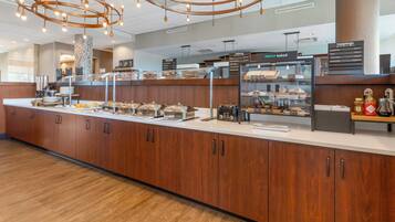A buffet area with a variety of food options, including a bakery section with fresh baked goods.