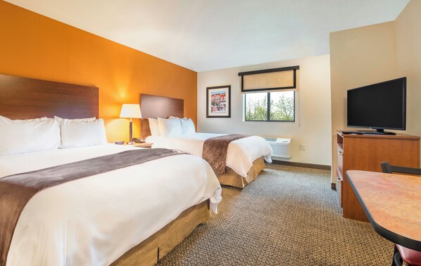 Premium bedding, pillow-top beds, desk, laptop workspace