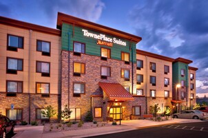 TownePlace Suites Marriott with a brick facade, multiple windows, and a well-lit entrance.