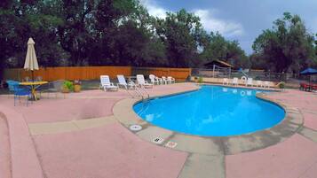 Seasonal outdoor pool, open 9:00 AM to 9:00 PM, pool loungers