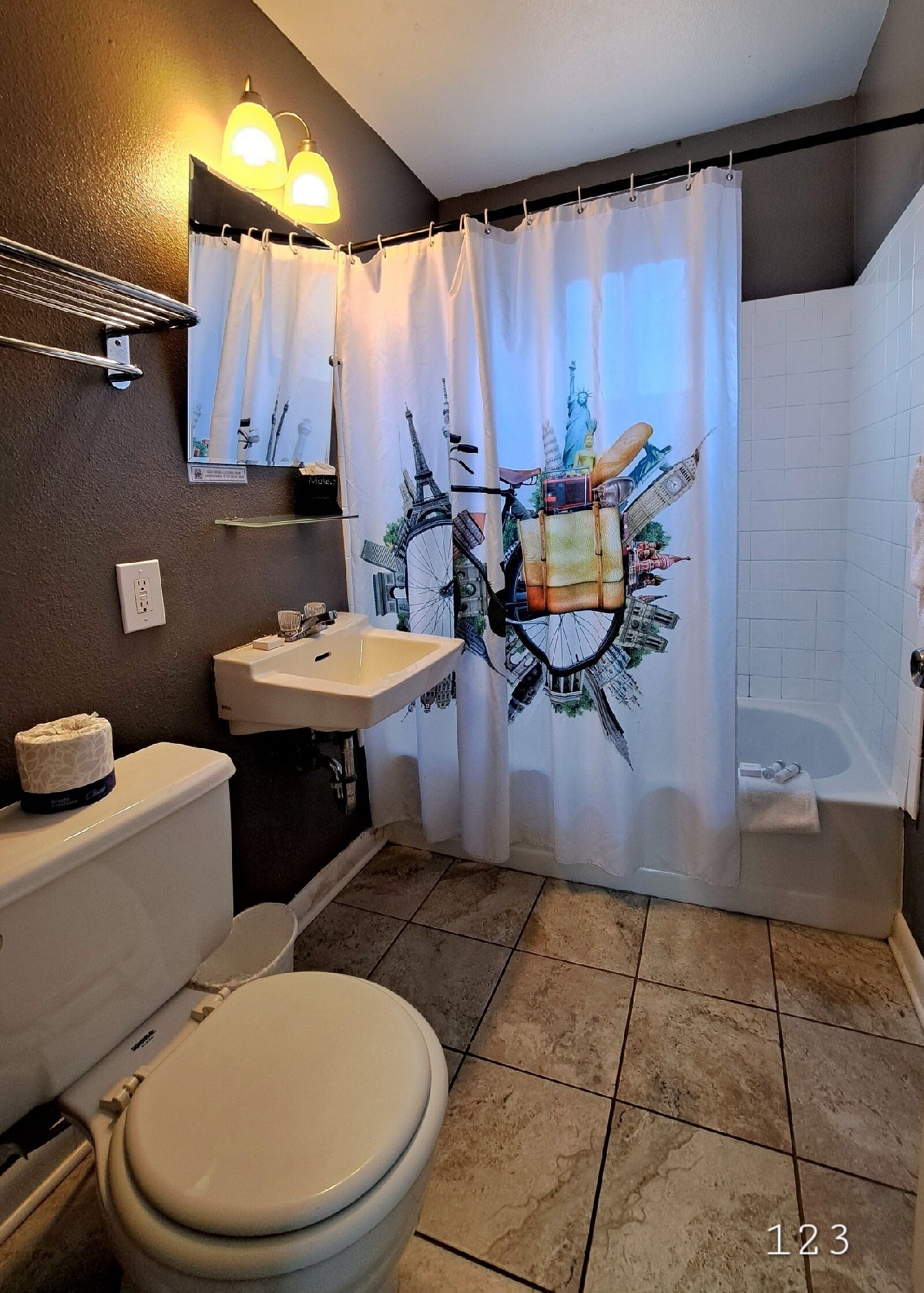 A bathroom with a toilet, sink, and bathtub.