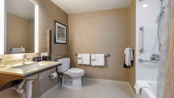 A modern bathroom with a sink, toilet, and bathtub.
