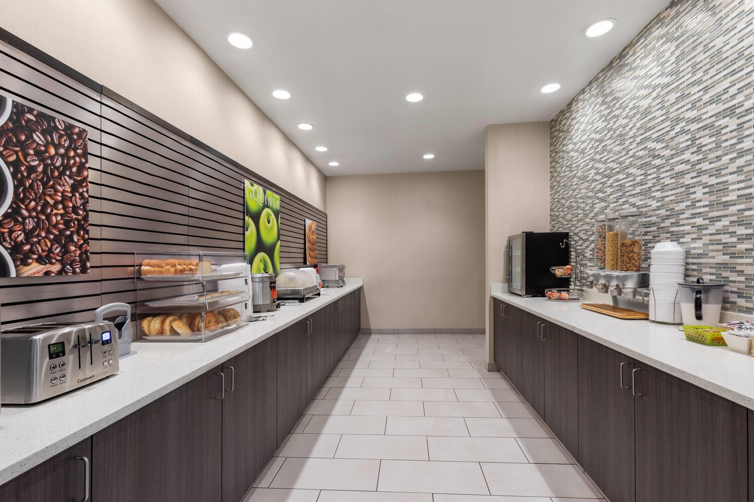 A modern kitchen with a toaster, bread, and a coffee machine.