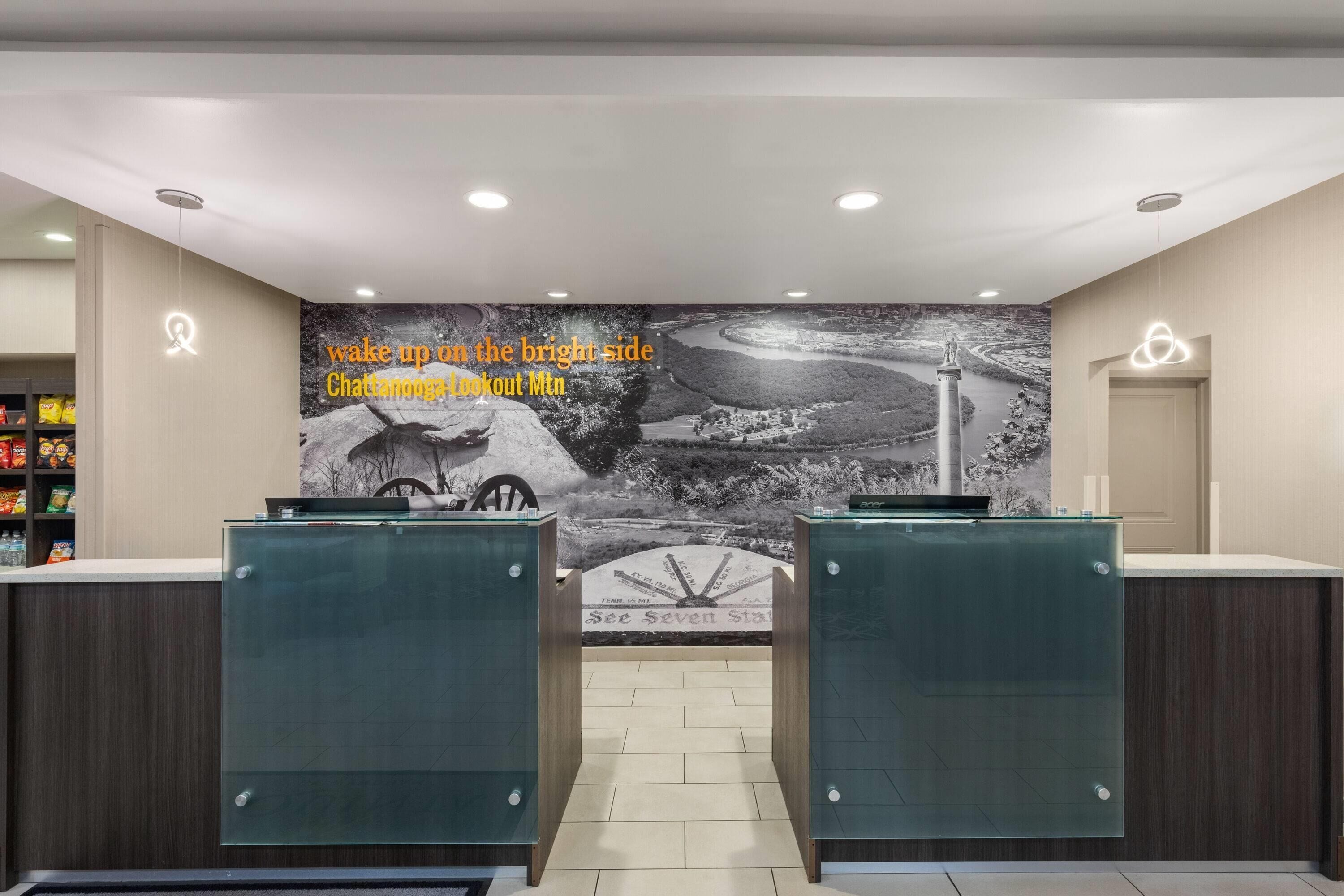 A reception area with a mural of Chattanooga Lookout Mountain, two glass-fronted counters, and a sign reading "See Seven Stars".