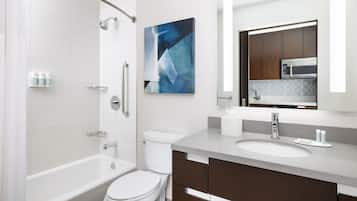 A modern bathroom with a bathtub, toilet, and sink.