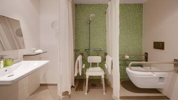 A bathroom with a shower, toilet, and sink.