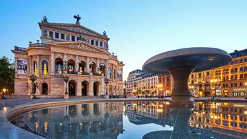 A historic building with arched windows and a central fountain.