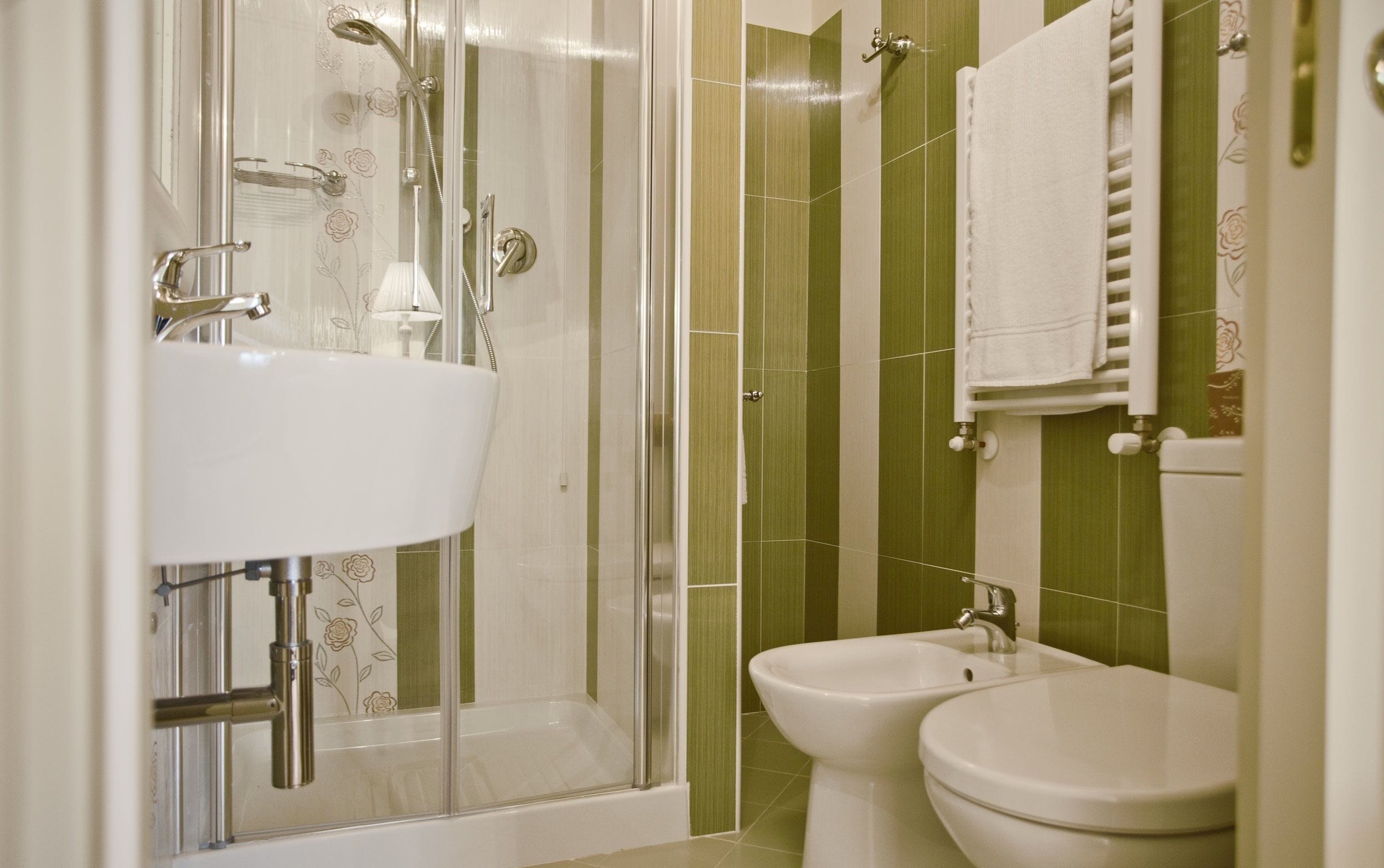 Une salle de bain avec une douche à parois de verre, un lavabo et des toilettes.