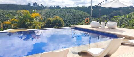 Outdoor pool, open 8:00 AM to 8:00 PM, pool loungers