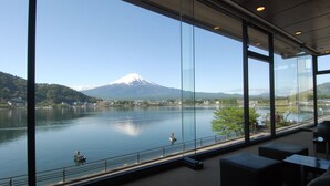 A view of Mount Fuji from a modern building with large windows overlooking a calm lake. - Ubuya (Fujikawaguchiko)