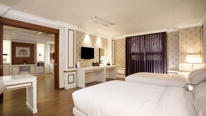 A hotel room with a large bed, a desk, a television, and a bathroom visible through an open door. - Prado Hotel (Gwangju)