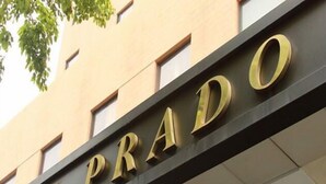 The exterior of a building with the name 'THE PRADO' prominently displayed in large, gold letters on a dark facade. - Prado Hotel (Gwangju)