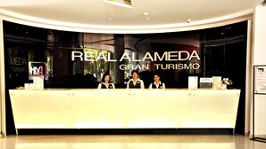 A reception desk at Real Alameda Gran Turismo with three staff members. - Hotel Real Alameda (Querétaro)