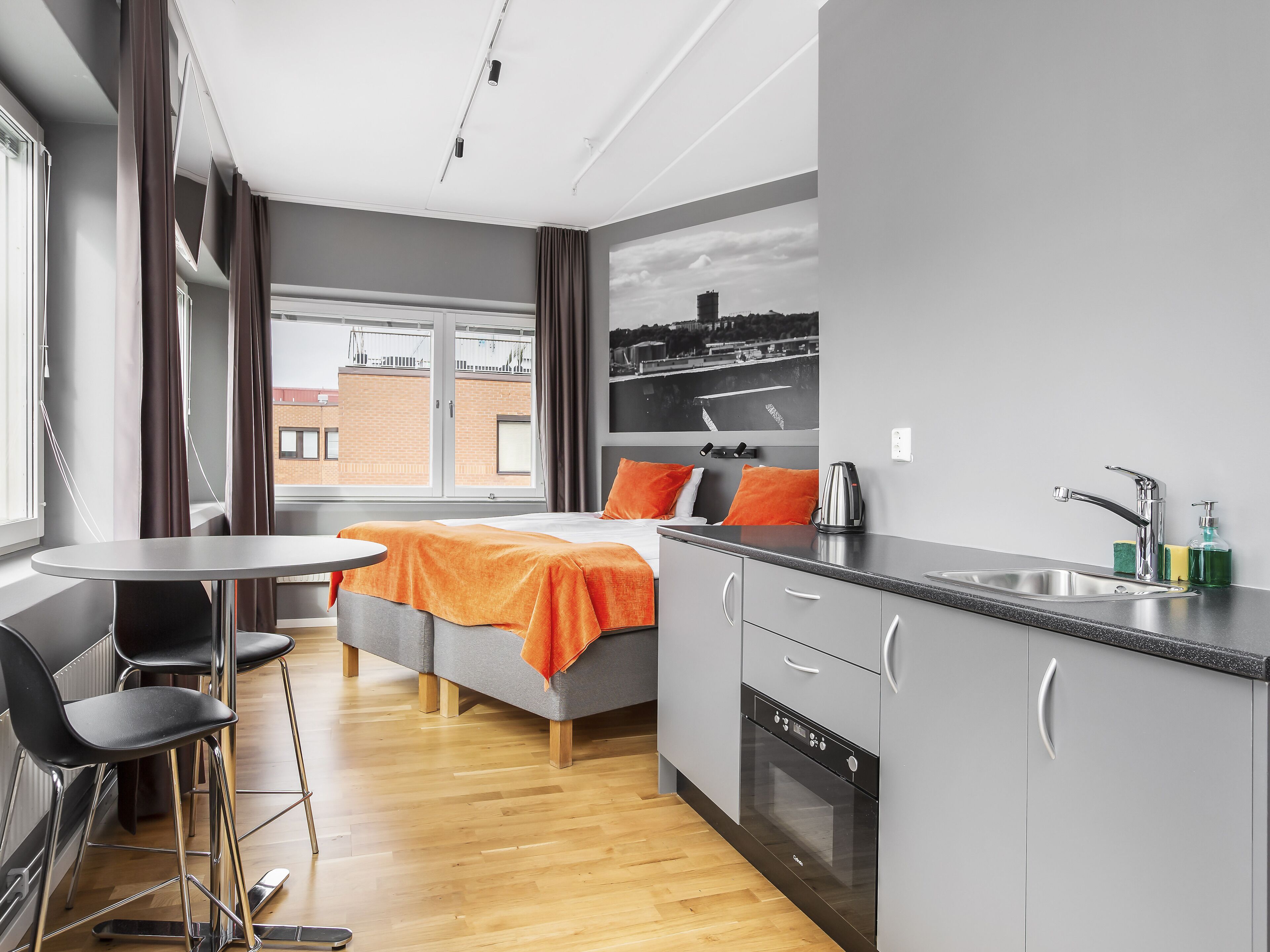 A modern kitchen with a dishwasher, a coffee maker, and a sink.