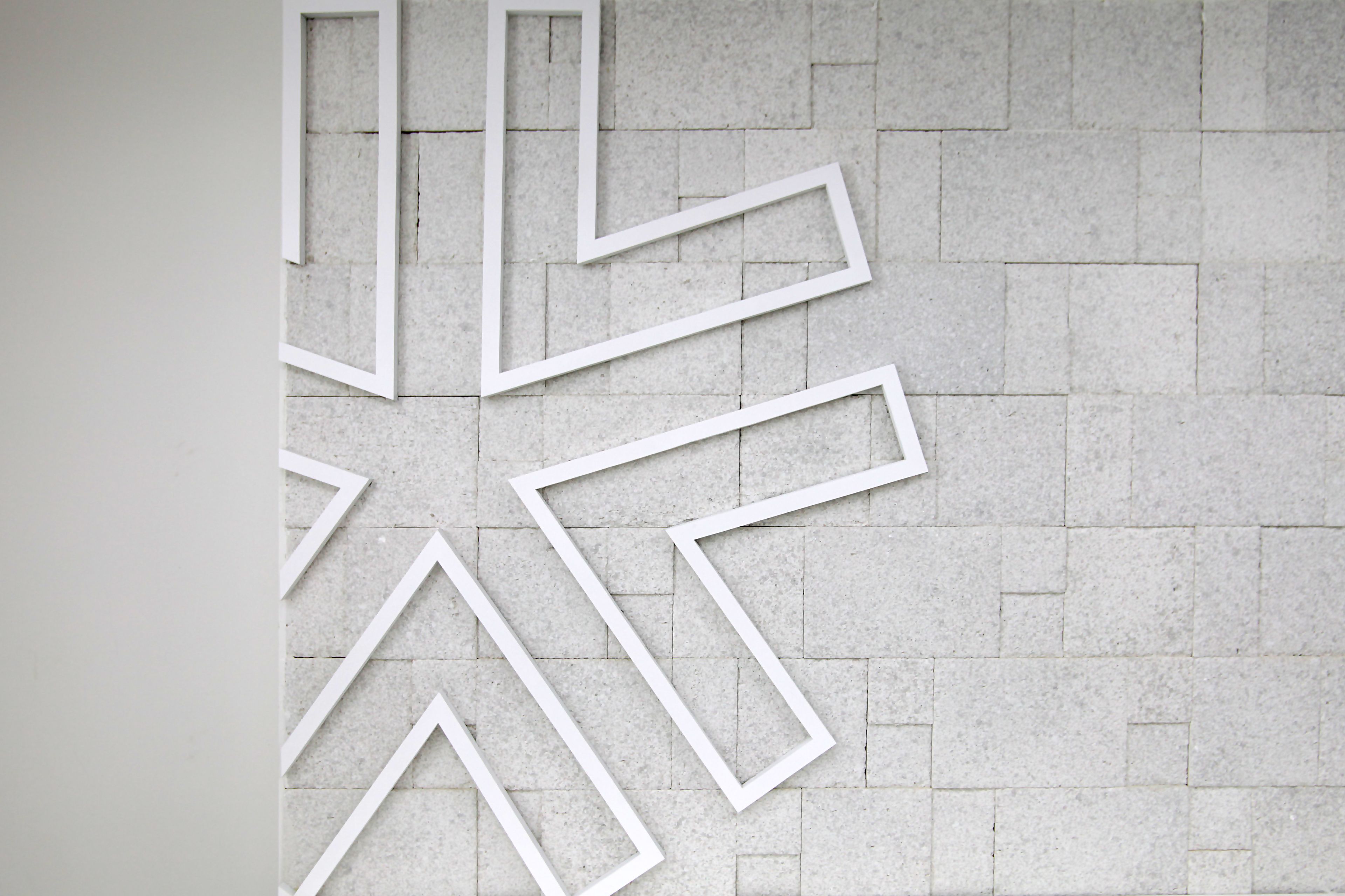 A wall with geometric white frames.