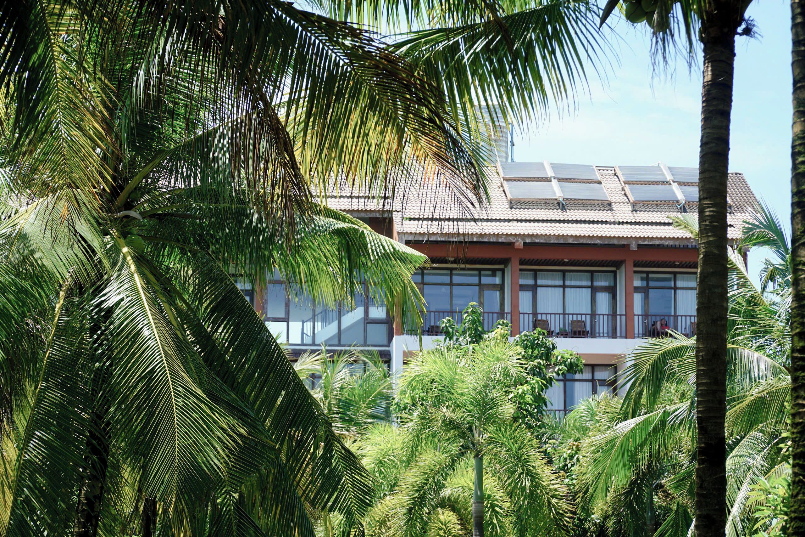 A modern building with large windows and a flat roof with solar panels.