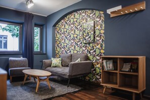 Grand Apartment | Living area | 32-inch Smart TV with satellite channels, TV, heated floors - The Circus Hotel (Berlin)