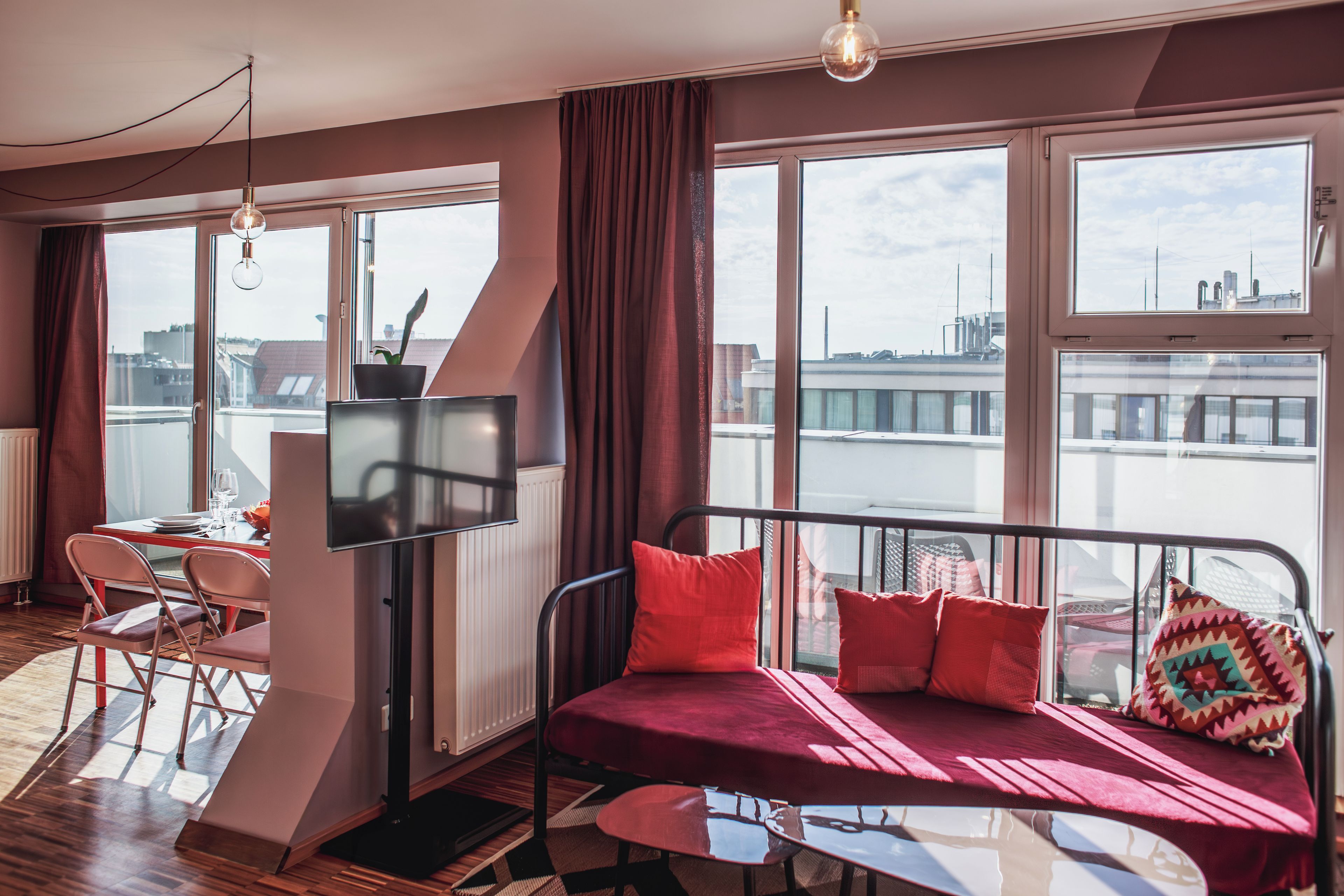 Una habitación moderna con sofá, mesa de comedor y televisión.
