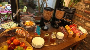A breakfast buffet with various food items, including fruits, cereals, and condiments. - Hotel La Chartreuse (Toulouse)