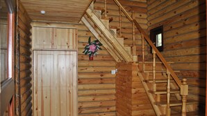A wooden interior with a staircase, a door, and a small window. - Elki-Palki (Sovinion)