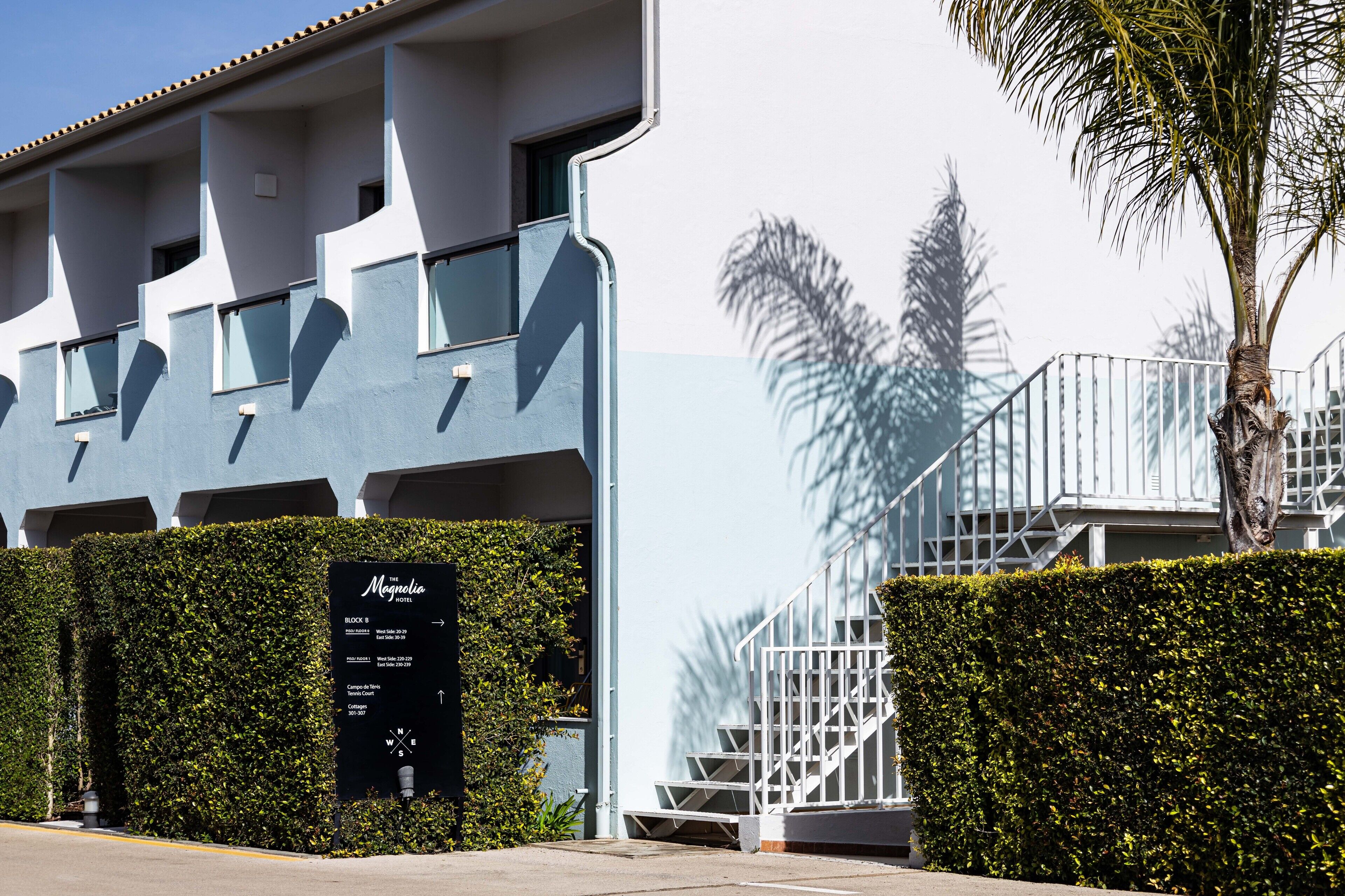 A modern building with a sign indicating 'Magnolia' and 'Block 8'.