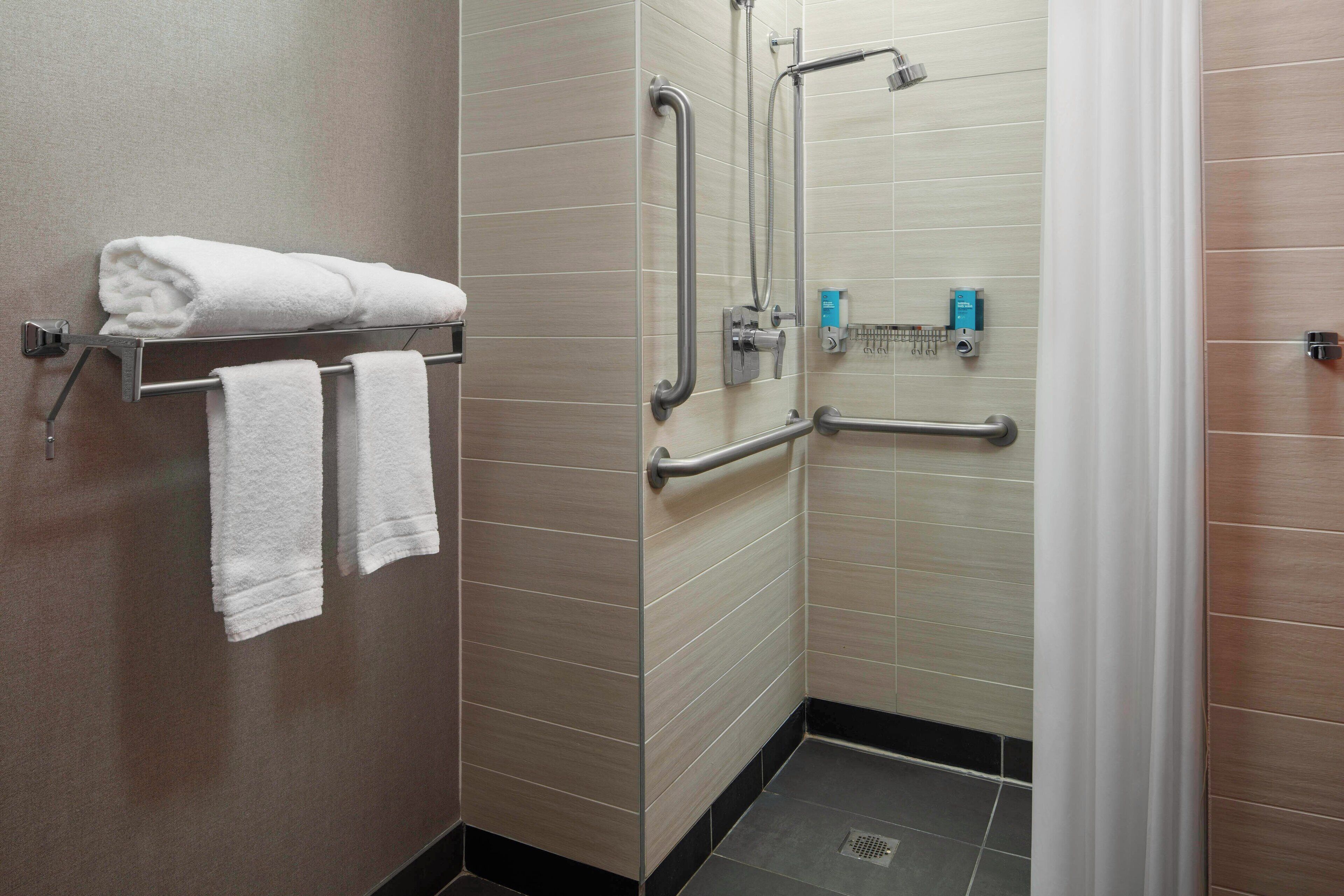 rainfall showerhead, designer toiletries, hair dryer, towels