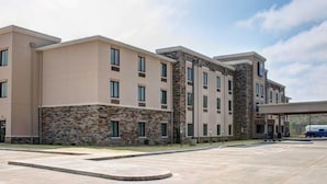 A multi-story hotel with a stone facade and large windows.