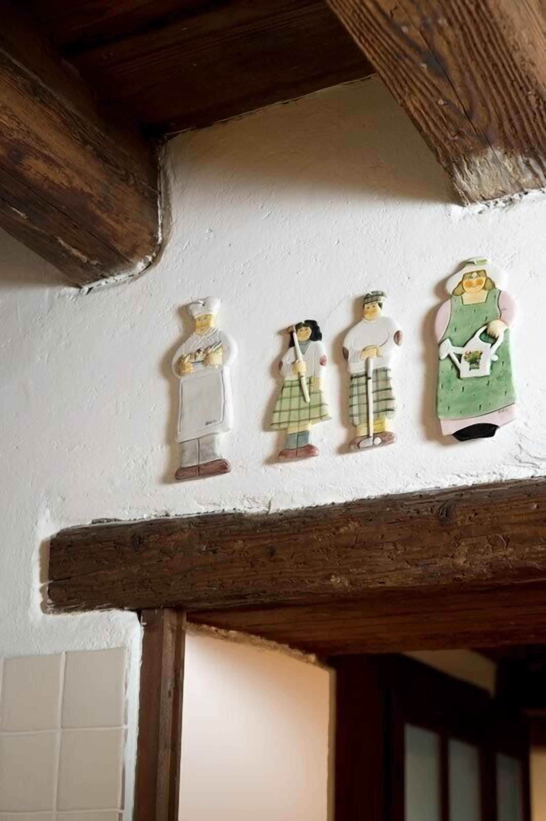 A rustic interior with wooden beams and a white wall.