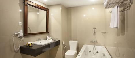 A modern bathroom with a vanity, toilet, bathtub, and towel rack.