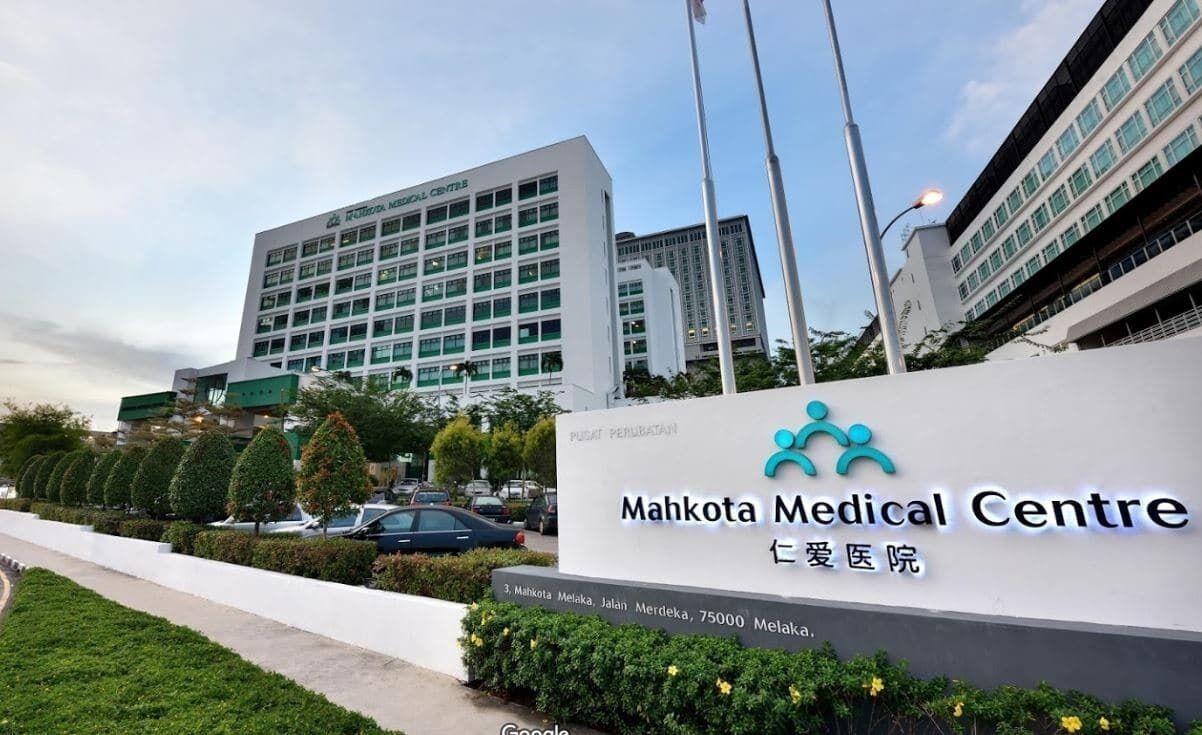A medical center with a sign reading "Mahkota Medical Centre" and "Ibu Hati Klinik".