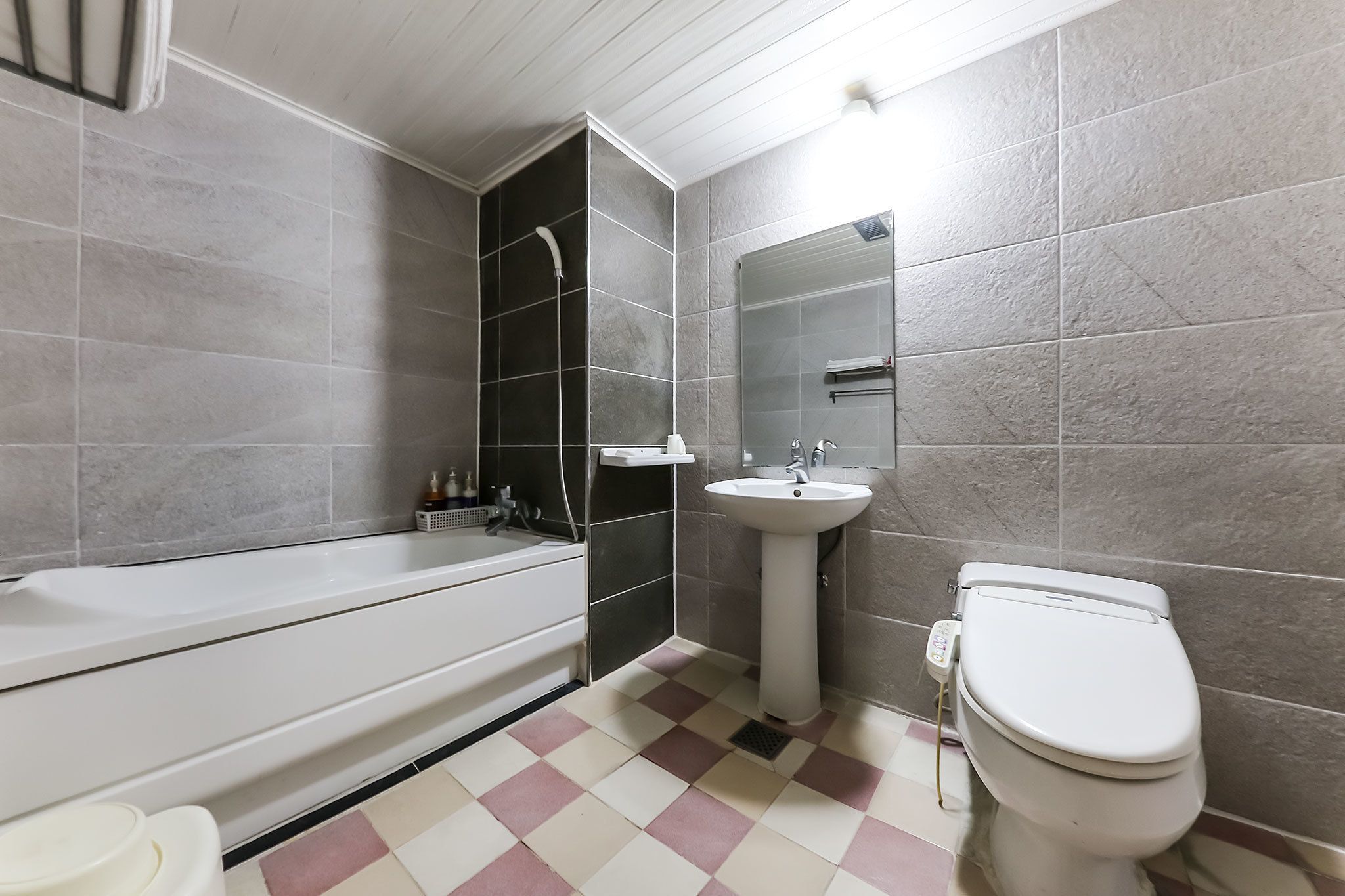 A bathroom with a bathtub, a sink, and a toilet.