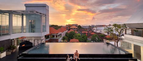 2 outdoor pools, open 7 AM to 8 PM, pool loungers