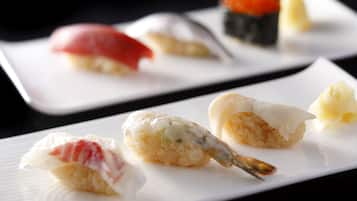 A variety of sushi dishes on a white plate.