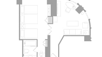 Plano de una habitación de hotel que incluye un baño, una kitchenette, una sala de estar y un dormitorio.