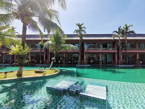 Una piscina al aire libre, sombrillas, tumbonas