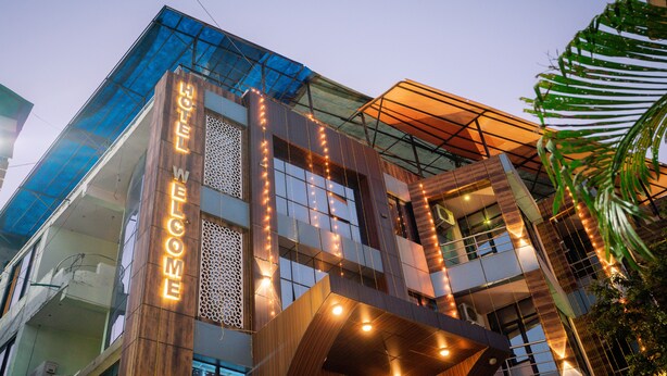 A modern hotel with a prominent 'WELCOME' sign, large windows, and a unique architectural design. - Hotel Welcome (Janakpur)