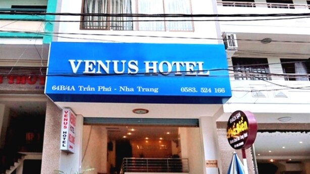 The exterior of Venus Hotel with a blue signboard displaying the name and address. - Venus Hotel (Nha Trang)