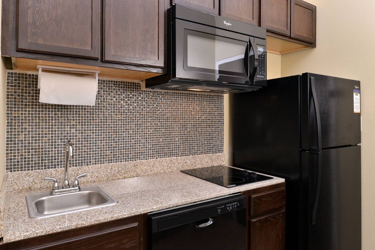 full-sized fridge, microwave, stovetop, dishwasher