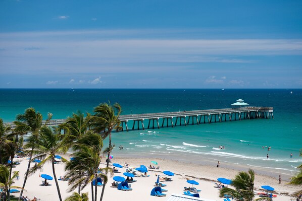 On the beach, white sand, sun loungers, beach umbrellas