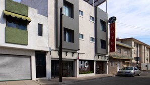 A hotel with a modern design, featuring a large sign with "HC HOTEL" and a visible entrance.