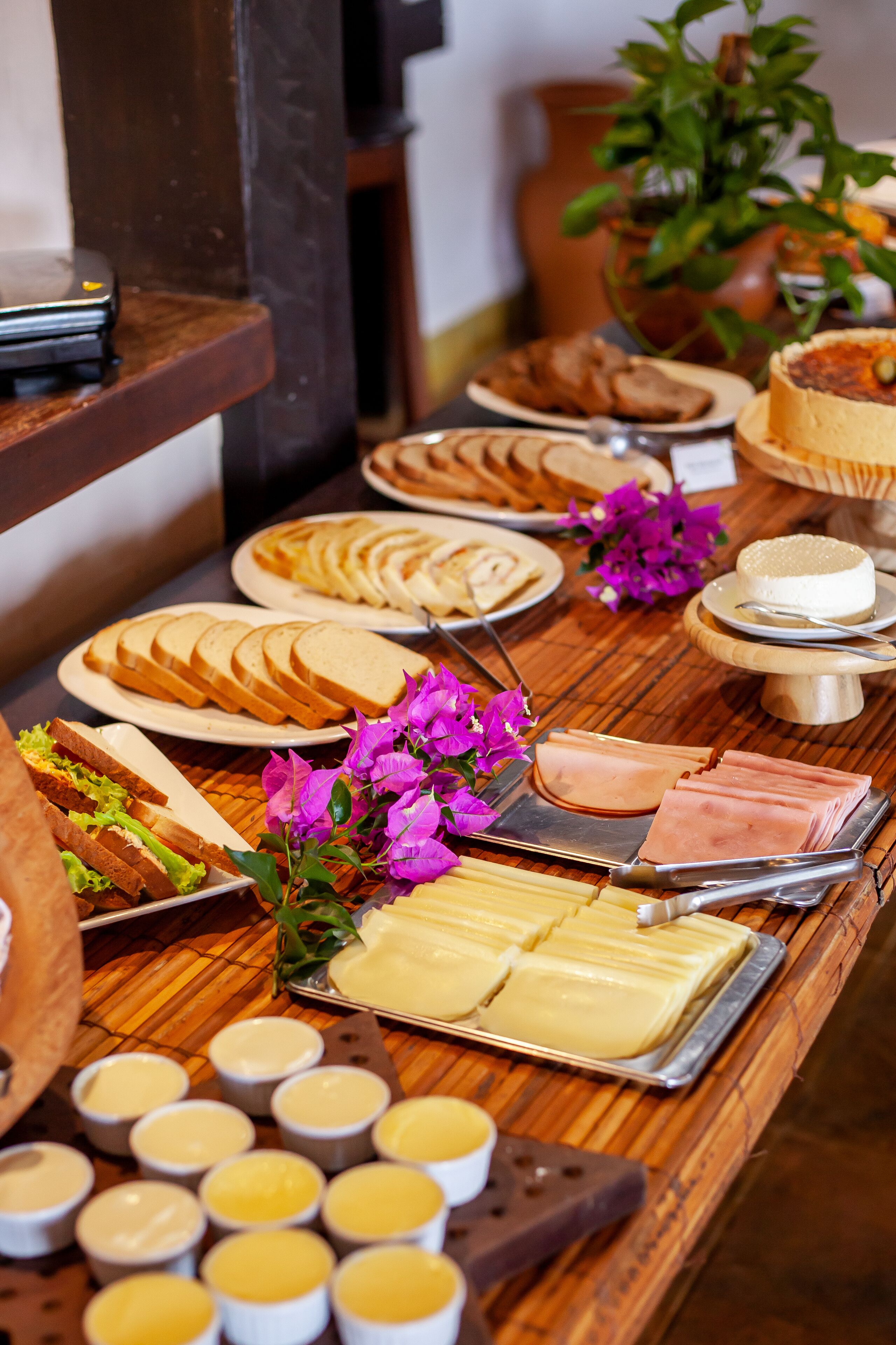 A buffet table with various food items including bread, cheese, and dips.