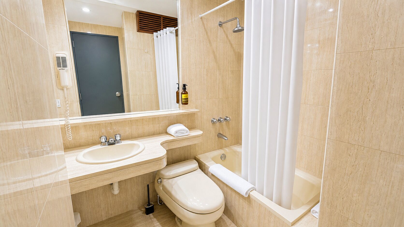 A bathroom with a sink, toilet, and shower.
