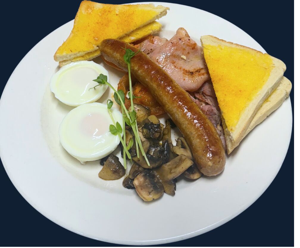 A plate with toast, eggs, sausage, and mushrooms.