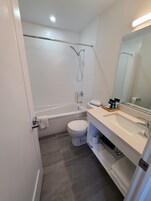 Habitación individual, 1 cama de matrimonio grande, frigorífico y microondas | Baño | Ducha y bañera combinadas y cabezal de ducha tipo lluvia